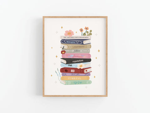The TS Book Stack Art Print by Onderkast Studio showcases vibrant books named after Taylor Swift albums, accented with flowers and stars on a crisp white background—perfect décor for any Swiftie’s space.