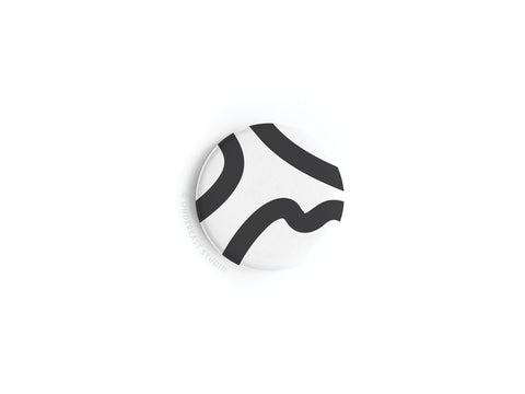 Onderkast Studio’s discontinued Abstract No. 3 Button Magnet features a black abstract curved line on white, displayed on a plain surface; made in the USA.