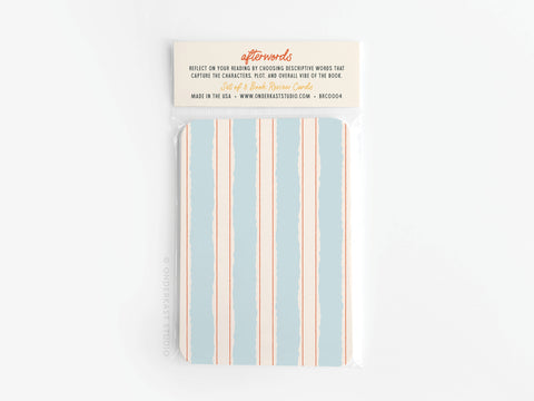 The Afterwords Book Review Card Set by Onderkast Studio features blue and cream stripes, vibrant colors, and comes wrapped in plastic. The top label explains how to use the cards for reflecting on reading experiences and book characters.