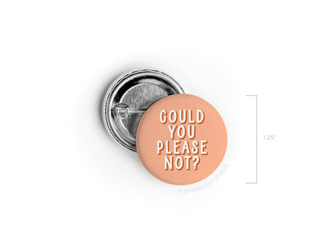 The Could You Please Not Pinback Button by Onderkast Studio is a discontinued, 1.25 round peach pin with white text, shown beside its metal backing.