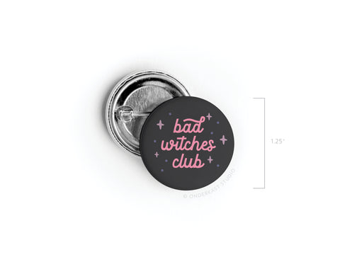 The Bad Witches Club Pinback Button by Onderkast Studio features pink text on black with purple and pink stars. Measuring 1.25 in diameter, it’s perfect for fans of mystical sisterhoods.