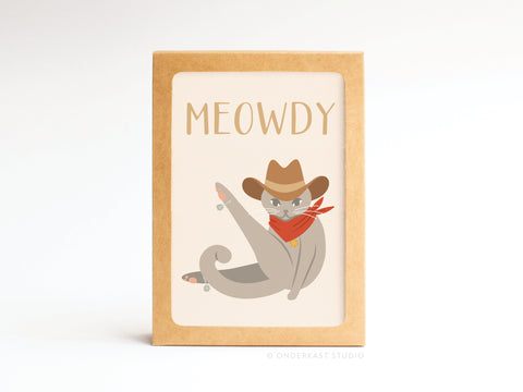 The Meowdy Folded Greeting Note Set of 10 by Onderkast Studio features a charming gray cat in a cowboy hat and red bandana with MEOWDY in vibrant colors—perfect for sending fun, eye-catching greetings.