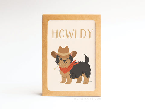 The Onderkast Studio Howldy Folded Greeting Note Set of 10 features cards with an illustrated dog in a cowboy hat and red bandana under “HOWLDY,” printed on premium US-made card stock. Cards are displayed upright against a plain background.