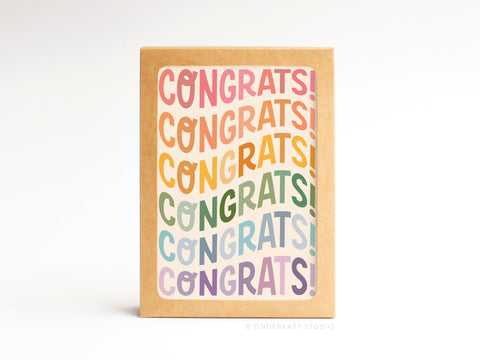 The Onderkast Studio Congrats Wonky Type Folded Greeting Note Set of 10 features a brown box with a vibrant, wavy CONGRATS! label for a premium feel against a crisp white background.