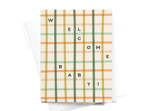 The Welcome Baby Gingham Greeting Card by Onderkast Studio features a green, brown, yellow, and orange plaid design with WELCOME BABY! in black letters arranged vertically and horizontally across the front.