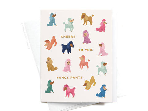 The Cheers to You Fancy Pants Poodles Greeting Card by Onderkast Studio features colorful poodles and gold CHEERS TO YOU, FANCY PANTS! text, complete with a partially visible white envelope for a premium touch.