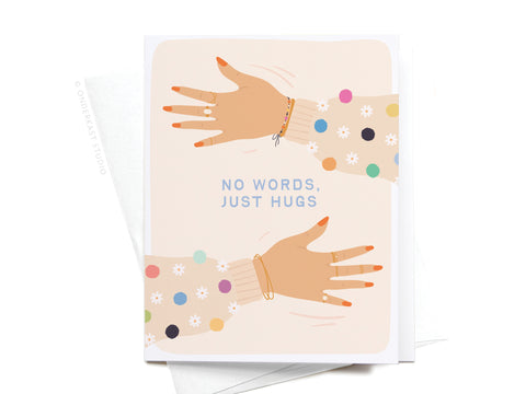 The No Words Just Hugs Greeting Card by Onderkast Studio features two hands in colorful sleeves reaching out on a sympathy card with NO WORDS, JUST HUGS centered. Premium design; white envelope included.