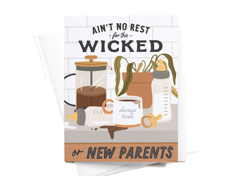 The Ain’t No Rest for the Wicked or New Parents Greeting Card by Onderkast Studio features colorful illustrations of baby bottles, spilled milk, a pacifier, coffee maker, plants, and a mug reading always tired.