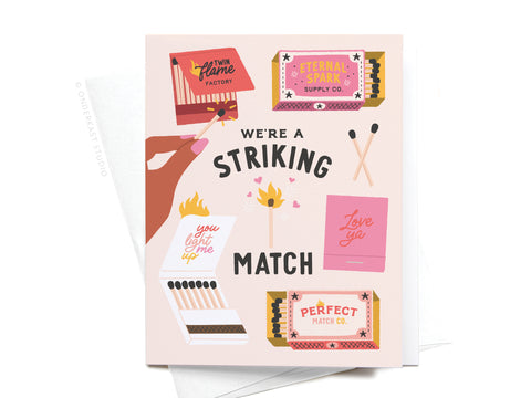 The Were a Striking Match Greeting Card by Onderkast Studio features matchboxes, matches, playful phrases like were a striking match, and a hand with a lit match—perfect as an anniversary card.
