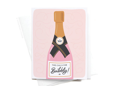 The This Calls for Bubbly Greeting Card by Onderkast Studio features a pink champagne bottle with gold cap and black label on a soft pink, swirl-accented background—perfect for celebrating any occasion.