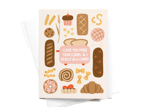 The I Love You More Than Carbs Greeting Card by Onderkast Studio features charming bread, pastries, and a cute mug illustration on a light background—perfect for carb lovers. Comes with a white envelope.