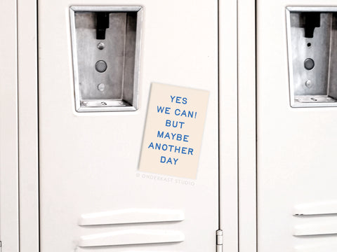 A We Can Another Day Refrigerator Magnet by Onderkast Studio, featuring bold blue “YES WE CAN! BUT MAYBE ANOTHER DAY” text on beige, adds a playful, laid-back vibe to any light gray locker or fridge.