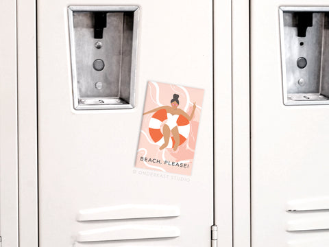 Add some coastal charm to your fridge with the Beach Please Refrigerator Magnet by Onderkast Studio, featuring an illustrated woman in a swimsuit on a life preserver and bold BEACH, PLEASE! text.