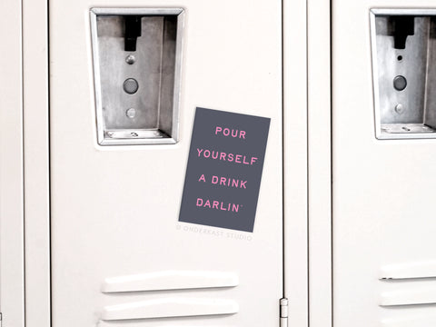 The Pour Yourself a Drink Darlin’ Refrigerator Magnet by Onderkast Studio adds a playful touch to your kitchen decor with its black card and pink text, making every beverage moment a bit more fun.