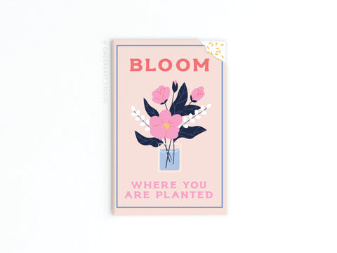 The Bloom Where You Are Planted Refrigerator Magnet by Onderkast Studio features pink and white flowers, gold corner detail, and the motivational message BLOOM WHERE YOU ARE PLANTED—perfect for inspirational decor.