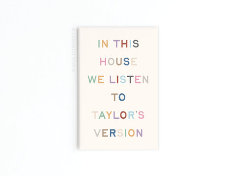 The Onderkast Studio Taylor’s Version Refrigerator Magnet features pastel letters on white reading: IN THIS HOUSE WE LISTEN TO TAYLORS VERSION—a perfect pick for any Swiftie.