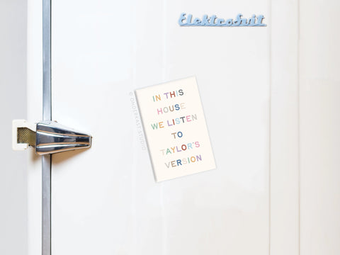 A white vintage fridge with a silver handle and Elektrobit label features the Onderkast Studio Taylor’s Version Refrigerator Magnet, declaring, “In this house we listen to Taylors Version”—perfect for Swifties.