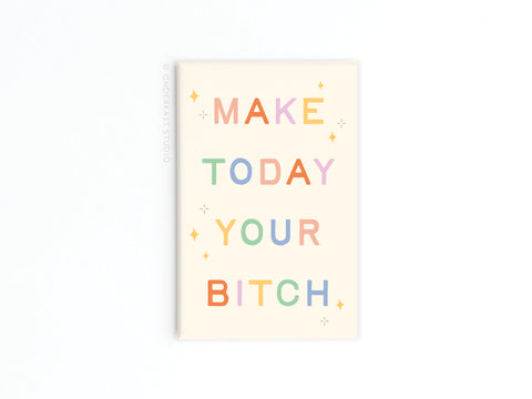 The Onderkast Studio Make Today Your Bitch Refrigerator Magnet features bold, motivational text and small yellow sparkles on a cream-colored background with vibrant print.