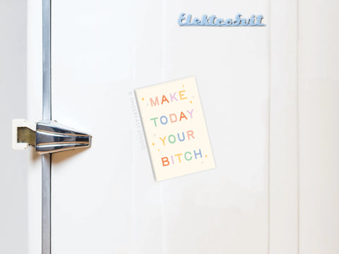 A white fridge with a chrome handle displays the Onderkast Studio Make Today Your Bitch Refrigerator Magnet in vibrant colors and bold letters. The word “Elektrohit” is visible at the top right of the door.