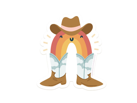 The Rainbow Cowboy Sticker by Onderkast Studio features a smiling cartoon rainbow in a cowboy hat and blue cloud boots. This durable, upright vinyl sticker is water resistant and adds fun to any surface.