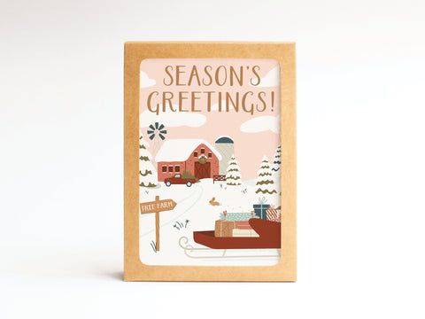 The Seasons Greeting! Tree Farm Folded Greeting Note Set of 10 by Onderkast Studio features a snowy farm scene with a red truck and wrapped gifts, framed in brown, and printed in the USA on premium card stock.