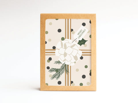 The Merry Christmas! Gift Wrapping Folded Greeting Note Set of 10 by Onderkast Studio features festive cards with a white bow, fir sprig, gold ribbon lines, and polka dots in brown kraft envelopes—printed in the USA on premium card stock.