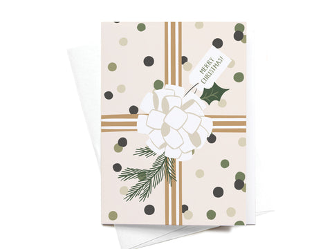 Onderkast Studio’s Merry Christmas! Gift Wrapping Folded Greeting Note Set of 10 features cards printed in the USA with a present, gold ribbon, white bow, pine sprigs, and polka dots on premium beige card stock.