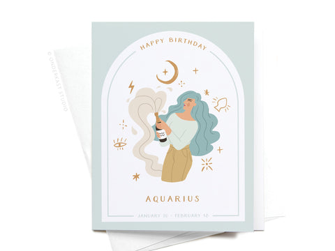 Onderkast Studio’s Happy Birthday Aquarius Zodiac Greeting Card features a blue-haired woman popping champagne amid zodiac symbols and sparkles. Front text: “Happy Birthday AQUARIUS January 20 – February 16.” Premium birthday card.