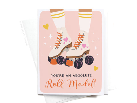Illustration of legs in cream roller skates with pink hearts and orange wheels on a pink background. The Roll Model Roller Skates Greeting Card by Onderkast Studio features the phrase YOURE AN ABSOLUTE Roll Model! and exudes nostalgic charm.