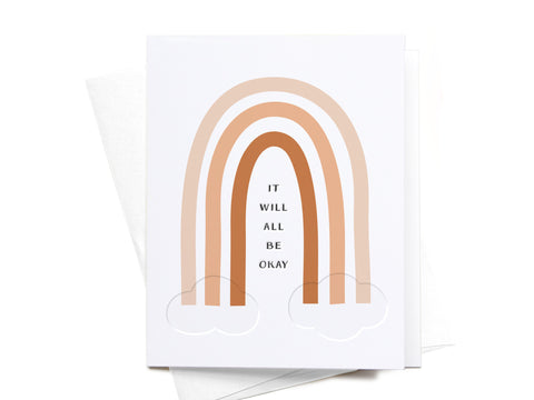 The Onderkast Studio It Will All Be Okay Rainbow Letterpress Greeting Card features brown and beige arches above clouds with the message at the center, shown on a white envelope.