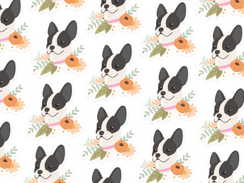 The French Bulldog Floral Sticker by Onderkast Studio features cartoon black and white French bulldogs with pink collars, orange flowers, green leaves, and stars on a water- and sunlight-resistant white vinyl.