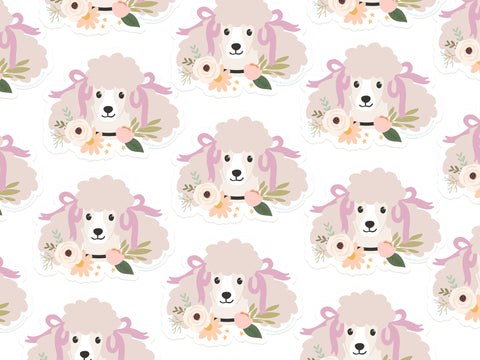 The Poodle Floral Sticker by Onderkast Studio features illustrated poodle faces with pinkish fur and purple bows, surrounded by pastel flowers and green leaves on a white background—perfect for vibrant, colorful decor.