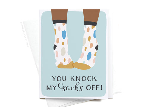 The You Knock My Socks Off Greeting Card – FINAL STOCK by Onderkast Studio features playful polka dot socks and the phrase “You knock my socks off!” on a light blue background—an adorable, premium-quality card for any occasion.
